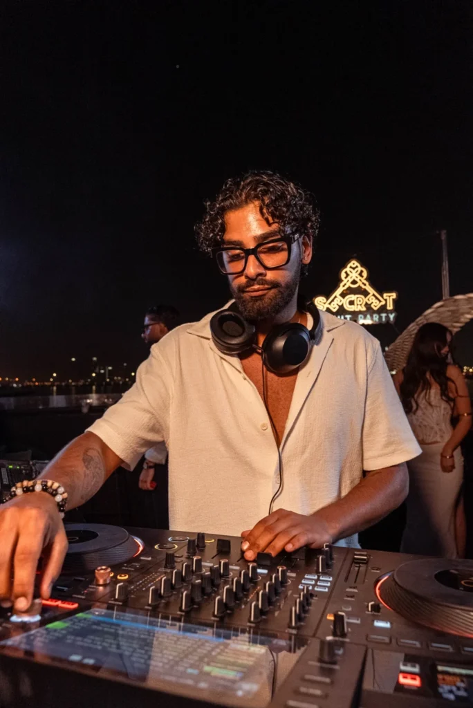 DJ playing on the deck of a Secret Yacht Party yacht in Dubai